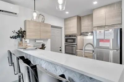a kitchen with a large white counter top at Contemporary 3BR 3 BA Duplex, Amazing Outdoor Area in Fort Lauderdale