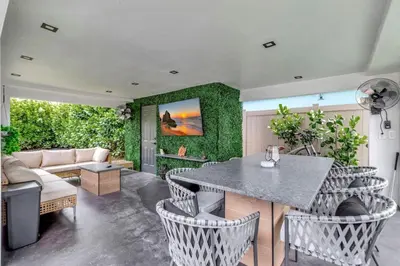 a living room with a table and chairs and a couch at Contemporary 3BR 3 BA Duplex, Amazing Outdoor Area in Fort Lauderdale