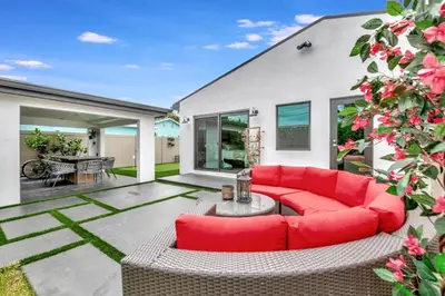 a living room with a red couch and a table at Contemporary 3BR 3 BA Duplex, Amazing Outdoor Area in Fort Lauderdale
