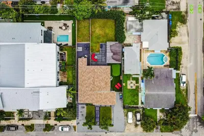 an overhead view of a yard with buildings at Lovely 2BR 2BA Modern Flat with Vibrant Backyard in Fort Lauderdale