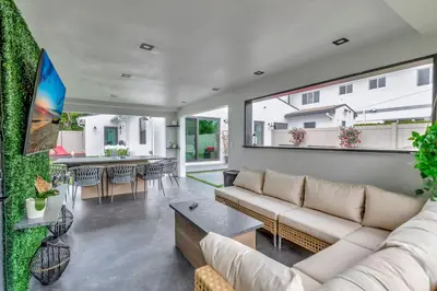 a living room with a couch and a table at Lovely 2BR 2BA Modern Flat with Vibrant Backyard in Fort Lauderdale