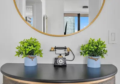 a table with two potted plants and a mirror at X Lounge II-Highline Corner Residence in Miami