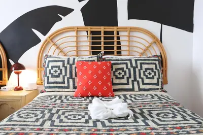 a bedroom with a bed with a wooden head board at Ocean Drive South Beach Miami in Miami Beach