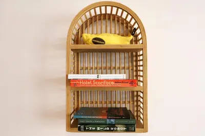 a bamboo book shelf with books and a yellow bag at Ocean Drive Steps to Sea in South Beach with Free Parking in Miami Beach