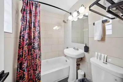 a bathroom with a sink and a shower curtain at Ocean Drive Steps to Sea in South Beach with Free Parking in Miami Beach
