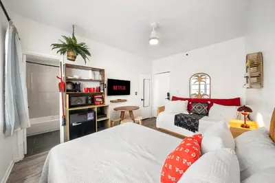 a living room with a couch and a bed at Ocean Drive Steps to Sea in South Beach with Free Parking in Miami Beach