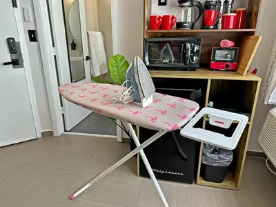 a pink table with a laptop on top of it at Ocean Drive Oasis in Art Deco District of South Beach in Miami Beach