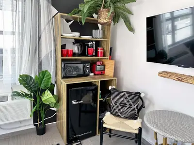 a living room with a book shelf and a table at Beachfront Ocean Drive South Beach Miami in Miami Beach