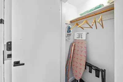 a surfboard is in a closet with a door at Beachfront Ocean Drive South Beach Miami in Miami Beach