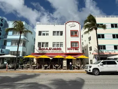 a white car parked in front of a hotel at Beachfront Ocean Drive South Beach Miami in Miami Beach