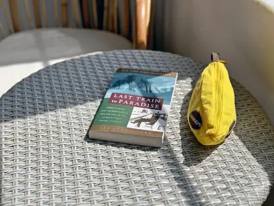 a book on a table next to a yellow purse at Ocean Drive Oasis Beach Views South Beach Miami in Miami Beach