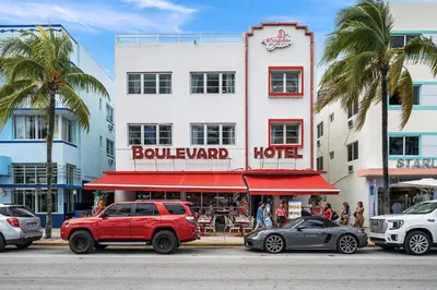 a red truck parked in front of a building at Ocean Drive Oasis Beach Views South Beach Miami in Miami Beach
