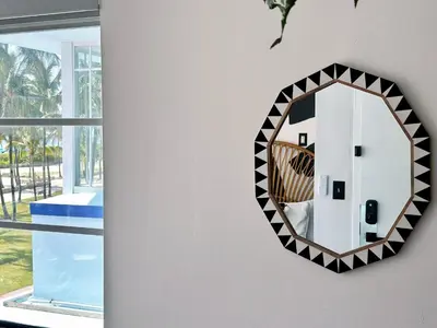 a mirror hanging on a wall next to a window at Ocean Drive Oasis Beach Views South Beach Miami in Miami Beach