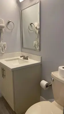 a bathroom with a sink and a toilet and a mirror at Spacious Private Room Close to Miami Attractions in Miami