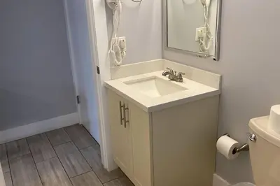 a bathroom with a sink and a mirror and a toilet at Spacious Private Room Close to Miami Attractions in Miami