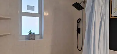 a shower in a bathroom with a window at Holliday 3-bedroom Private duplex House Parking WiFi BBQ Karaoke Available in Cutler Bay