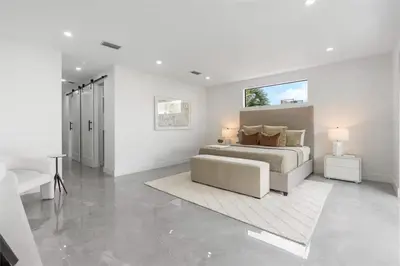 a white bedroom with a bed and a couch at Beautiful Property in Fort Laurderdale in Fort Lauderdale