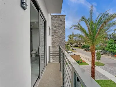 a balcony of a house with a palm tree at Beautiful Property in Fort Laurderdale in Fort Lauderdale