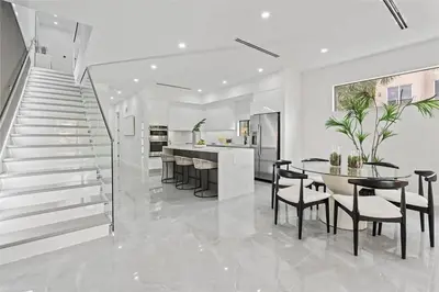 a kitchen and dining room with a staircase and a table and chairs at Beautiful Property in Fort Laurderdale in Fort Lauderdale