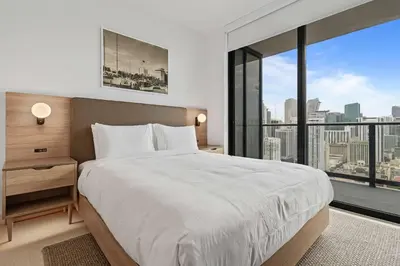 a bedroom with a large bed and a large window at Bayside Breeze - Downtown Luxury Tower in Miami