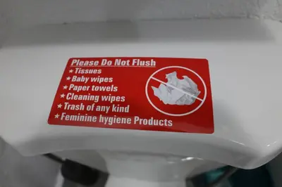a sign on the top of a toilet bowl at Private and Comfortable Suite near Airport Miami in Miami
