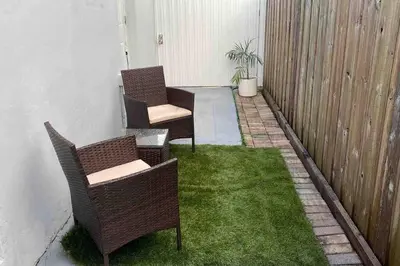 two chairs on a patio with green grass at Private and Comfortable Suite near Airport Miami in Miami