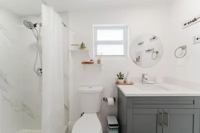 a white bathroom with a toilet and a sink at BOHO Elegance in the FLL city! in Fort Lauderdale