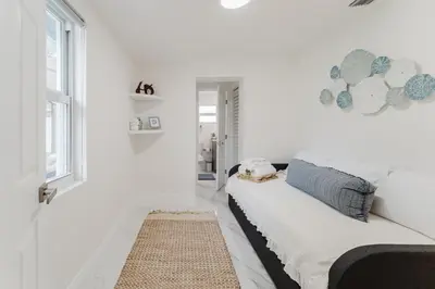 a white living room with a white couch and a rug at BOHO Elegance in the FLL city! in Fort Lauderdale