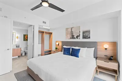 a bedroom with a large bed with blue pillows at NEW Luxurious Apartment Floor 35th - Miami's heart in Miami