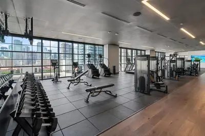 a gym with treadmills and machines in a building at NEW Luxurious Apartment Floor 35th - Miami's heart in Miami