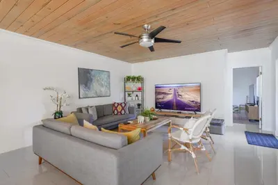 a living room with a couch and a ceiling fan at Charming House with Private Pool n Coral Gable in Miami