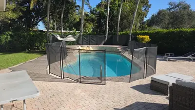 a swimming pool with a fence around it at Charming House with Private Pool n Coral Gable in Miami
