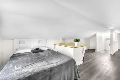 a white bedroom with a large bed and a desk at Contemporary 4 Bedroom Oasis - Private Large Patio in North Miami