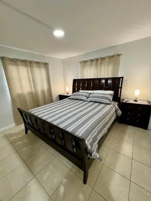 a bedroom with a large bed with a striped blanket at Apartment in Hollywood close to beach & shops 101 in Hollywood