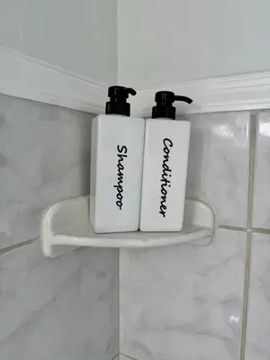 two white bottles on a shelf in a bathroom at Apartment in Hollywood close to beach & shops 101 in Hollywood