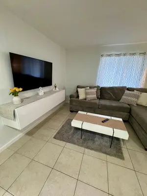 a living room with a couch and a flat screen tv at Apartment in Hollywood close to beach & shops 101 in Hollywood