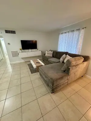 a living room with a couch and a flat screen tv at Apartment in Hollywood close to beach & shops 101 in Hollywood