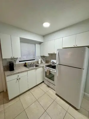 a kitchen with white cabinets and a white refrigerator at Apartment in Hollywood close to beach & shops 101 in Hollywood