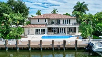 a house on the water with a dock at Elegant Waterfront Estate 6BR- 6.5BA in Fort Lauderdale