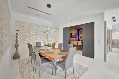 a dining room with a wooden table and chairs at Elegant Waterfront Estate 6BR- 6.5BA in Fort Lauderdale