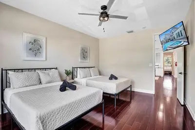 a bedroom with two beds and a ceiling fan at Spacious Luxury Villa in Hollywood 6BR 5-Bath 5-Min Walk to Beach & Attractions in Hollywood