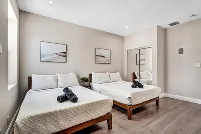 a bedroom with two beds and two mirrors at Spacious Luxury Villa in Hollywood 6BR 5-Bath 5-Min Walk to Beach & Attractions in Hollywood