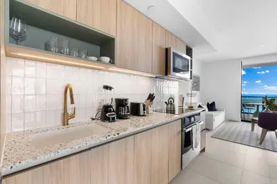 a kitchen with a sink and a counter at Lux Downtown Miami w Free Parking in Miami