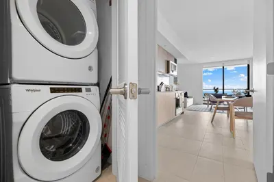 a washer and dryer in a room with a kitchen at Lux Downtown Miami w Free Parking in Miami