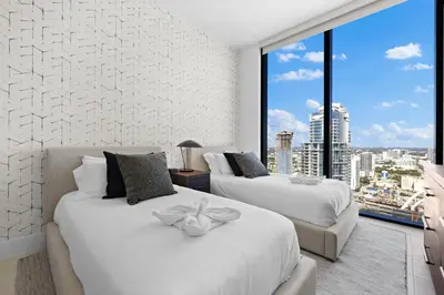 two beds in a room with a large window at Free Parking! PH Luxury 3BR in Downtown Miami in Miami