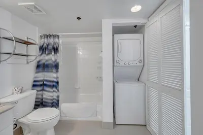 a white bathroom with a toilet and a sink at Amazing 28th floor unit with Parking in Miami