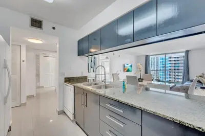 a kitchen with a sink and a counter top at Amazing 28th floor unit with Parking in Miami