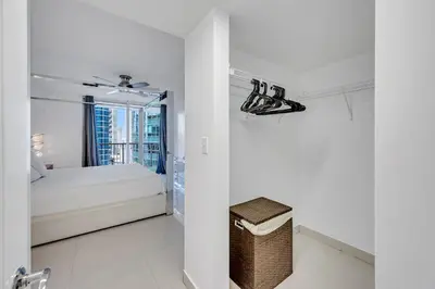 a white bedroom with a bed and a window at Amazing 28th floor unit with Parking in Miami