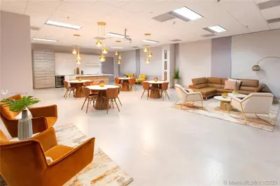 a waiting room with couches and tables and chairs at Amazing 28th floor unit with Parking in Miami
