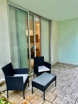 two chairs and a coffee table on a patio at Amazing beachfront condo at Tides on Hollywood Beach Luxury Resort in Hollywood